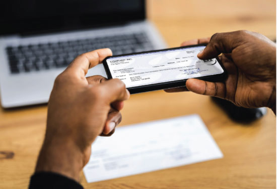 Black man scans a check for mobile deposit