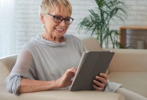 Senior woman banking online from home