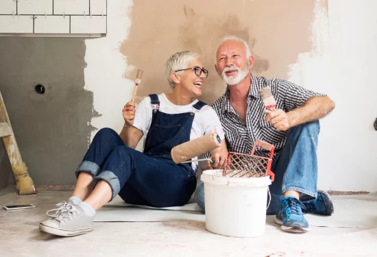 Two people sitting in an empty house, ready to remodel.