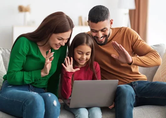 A family safely uses a laptop.