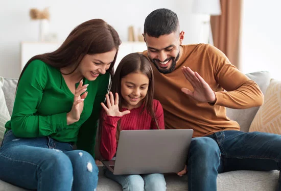 A family safely uses a laptop.