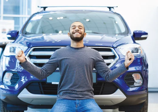 young adult male celebrating purchasing a new car