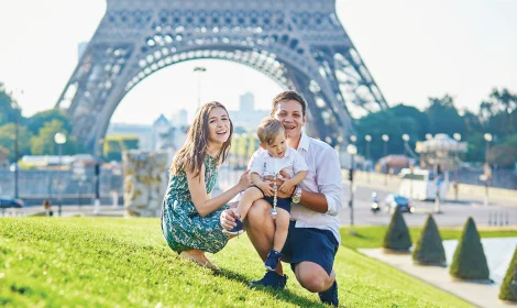 mother and father with young son enjoying their vacation to Paris, France photoed in front of Eiffel Tower