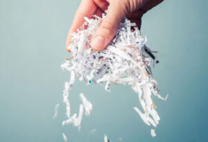 Hand holding shredded paper.