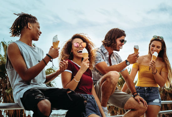 A group of college students enjoy an ice cream cone.