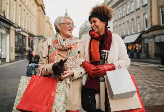 Two friends shop for holiday gifts.